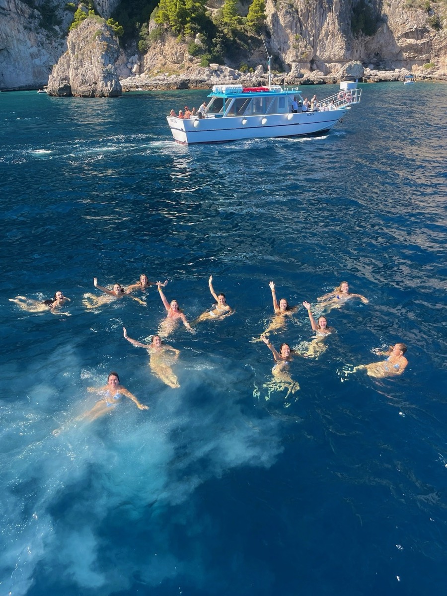 A group swimming off a boat